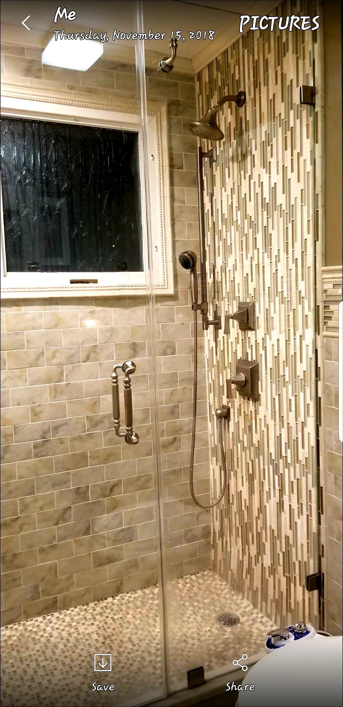 a bathroom with a walk in shower and a window.
