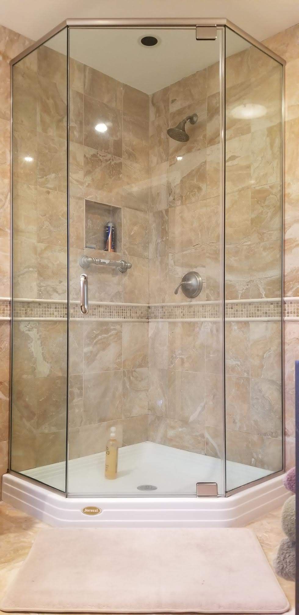 a shower stall with a glass door in a bathroom.