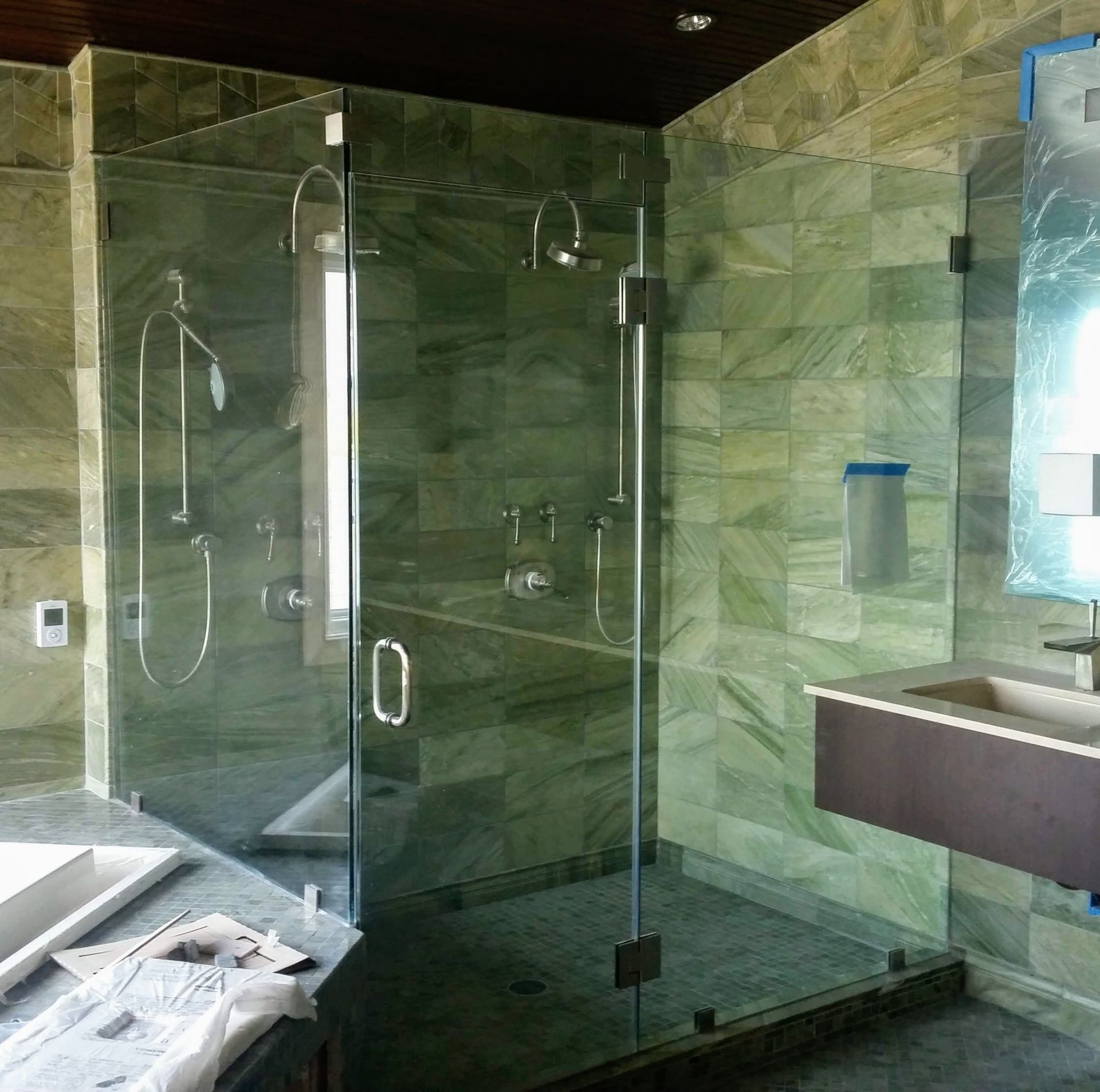 a bathroom with a walk in shower and a sink.