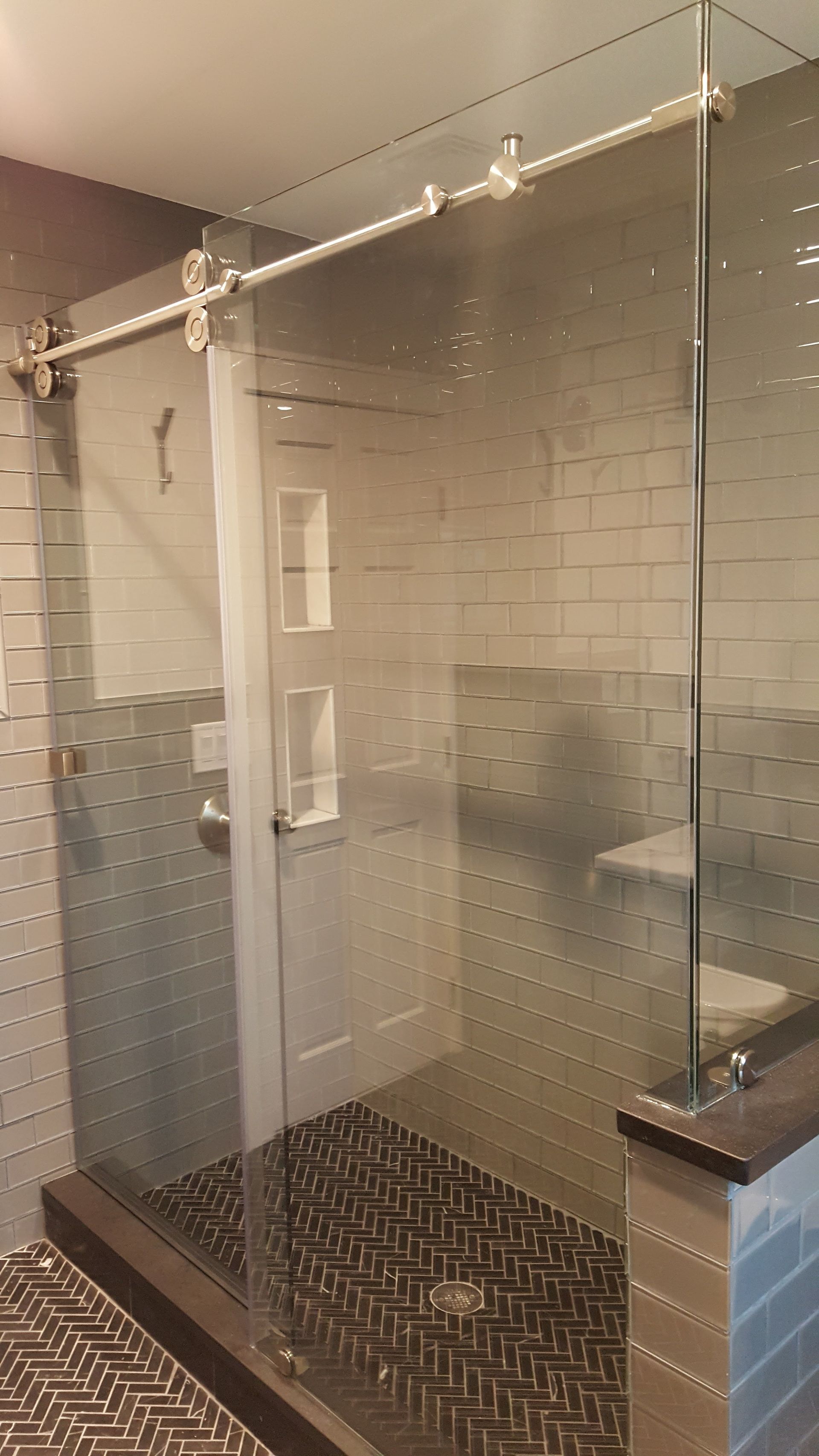 a bathroom with a sliding glass shower door and a toilet.