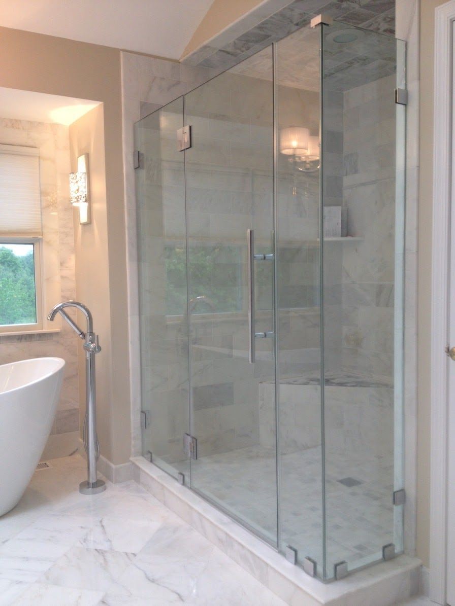 a bathroom with a walk in shower and a bathtub.