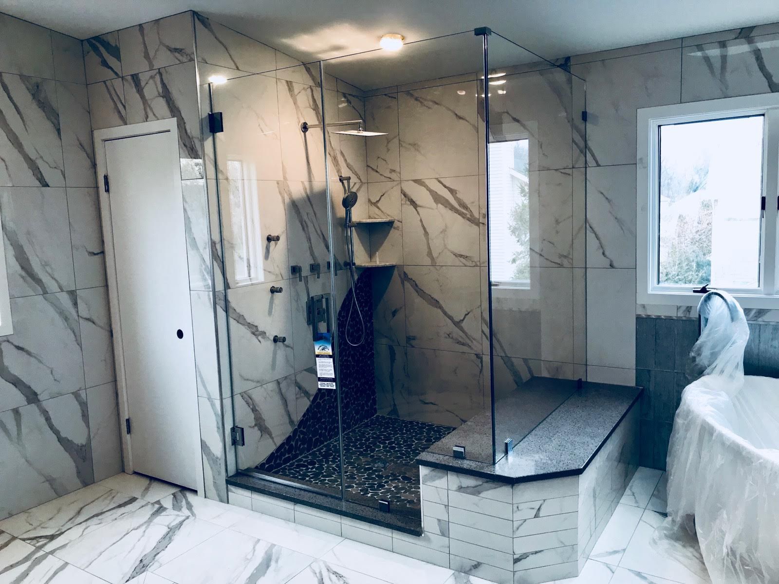 a bathroom with a walk in shower and a bathtub.