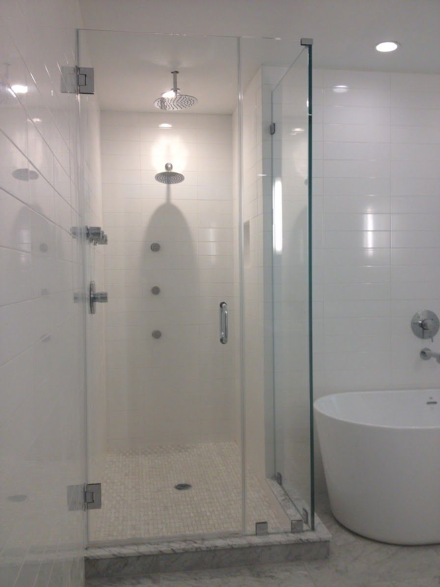 a bathroom with a walk in shower and a bathtub.