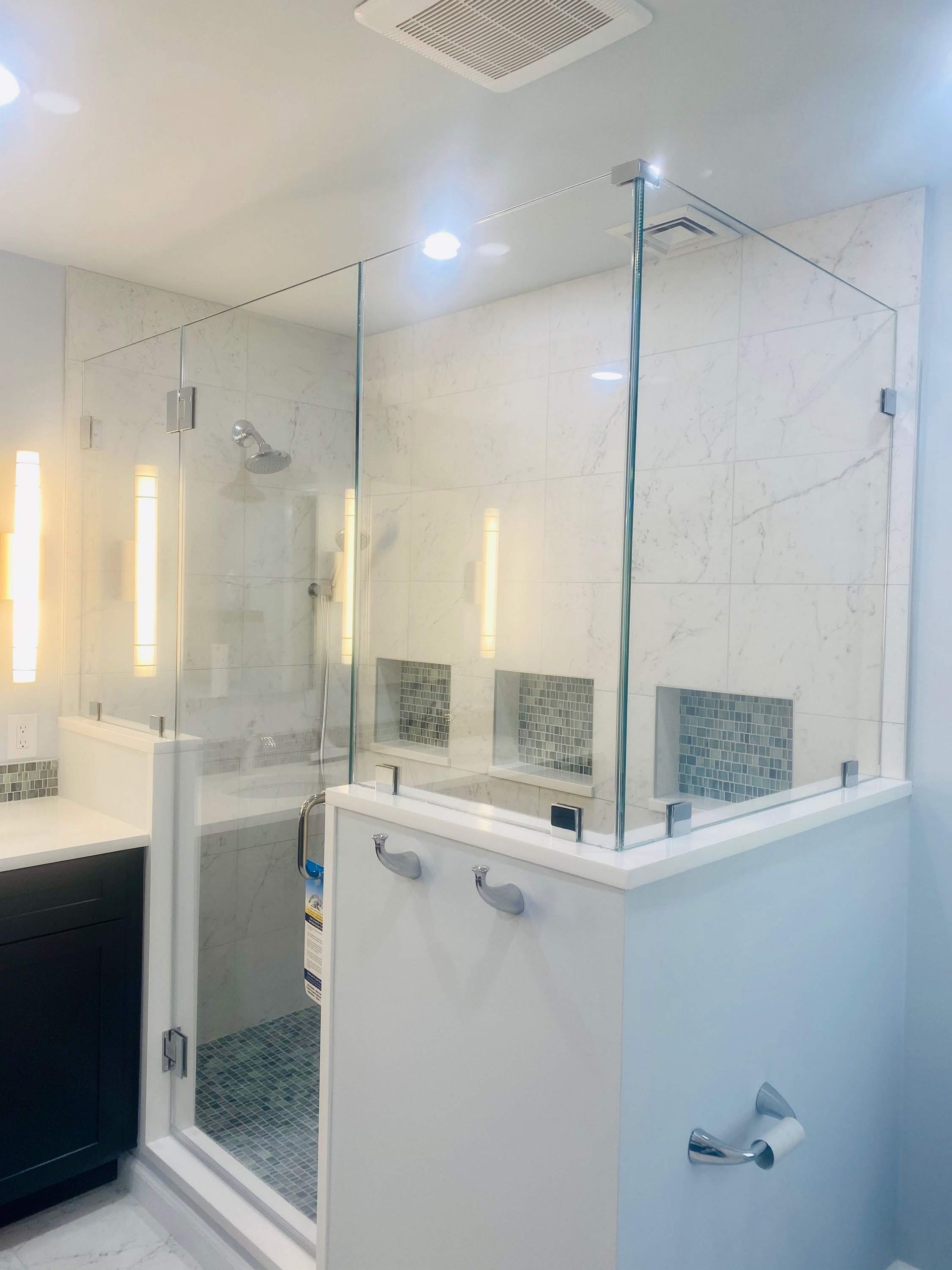 a bathroom with a glass shower door and a sink.
