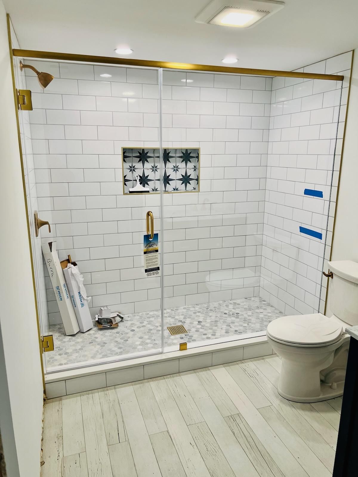 a bathroom with a walk in shower and a toilet.