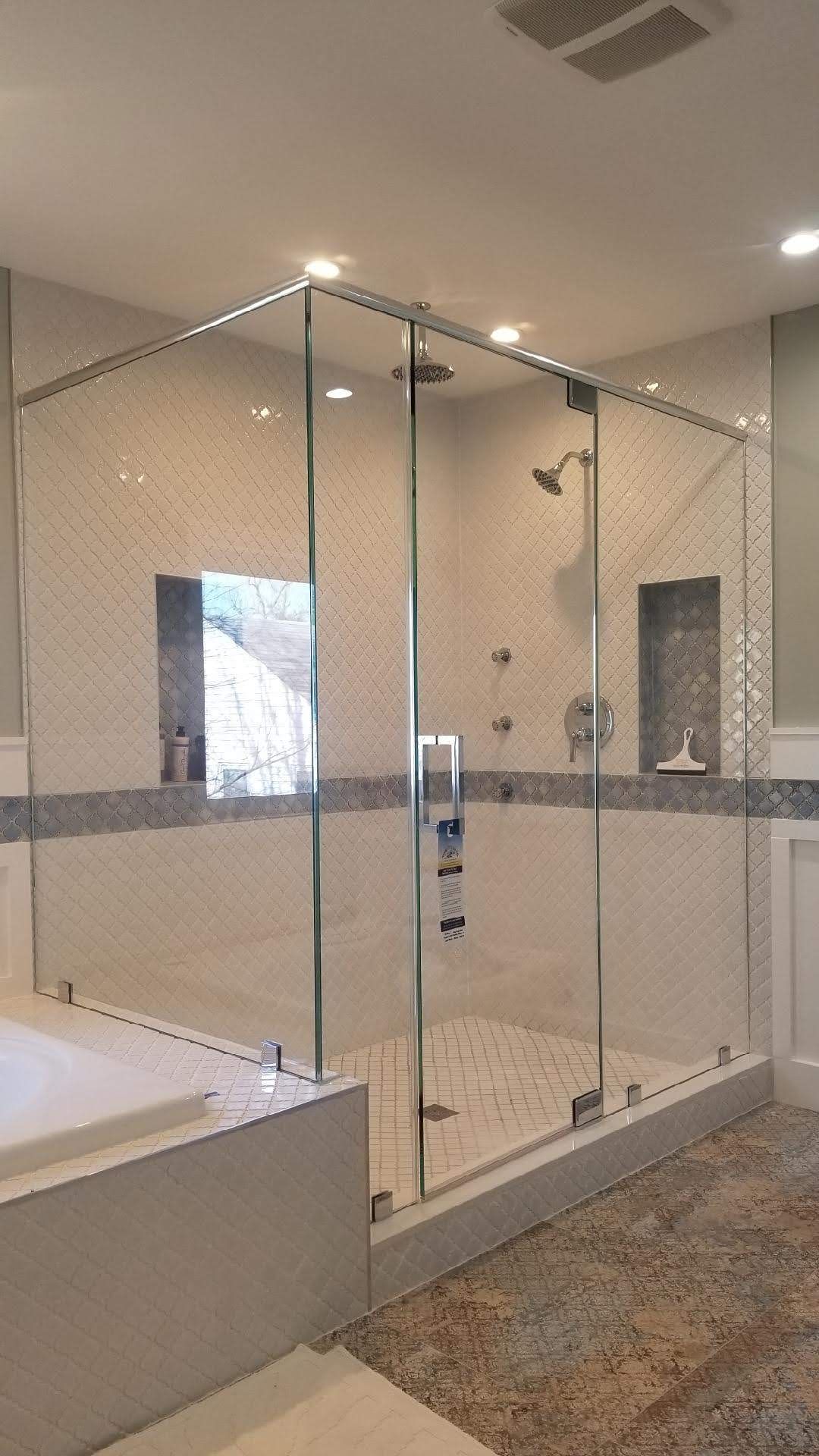 a bathroom with a walk in shower and a bathtub.