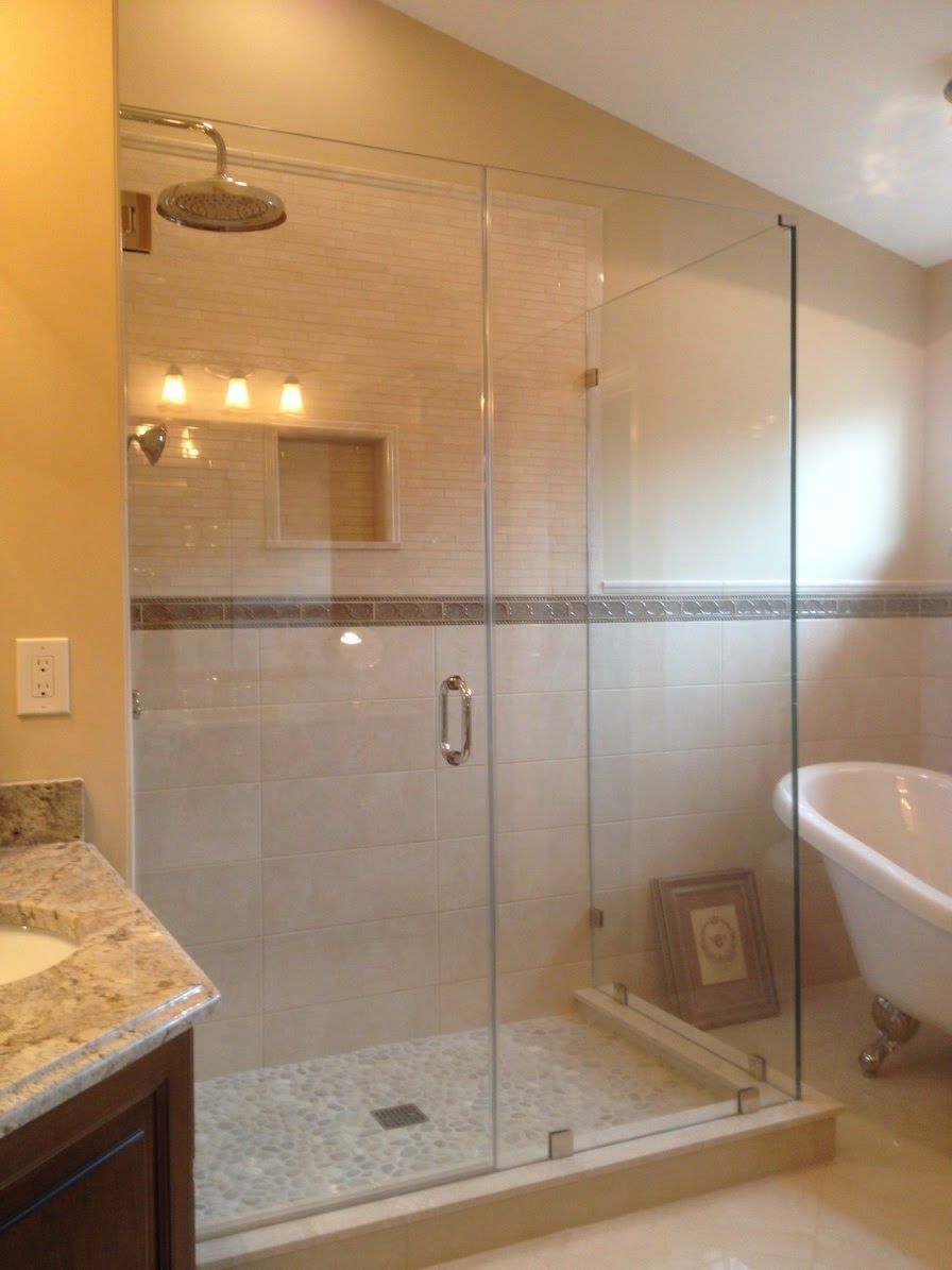 a bathroom with a walk in shower and a bathtub.
