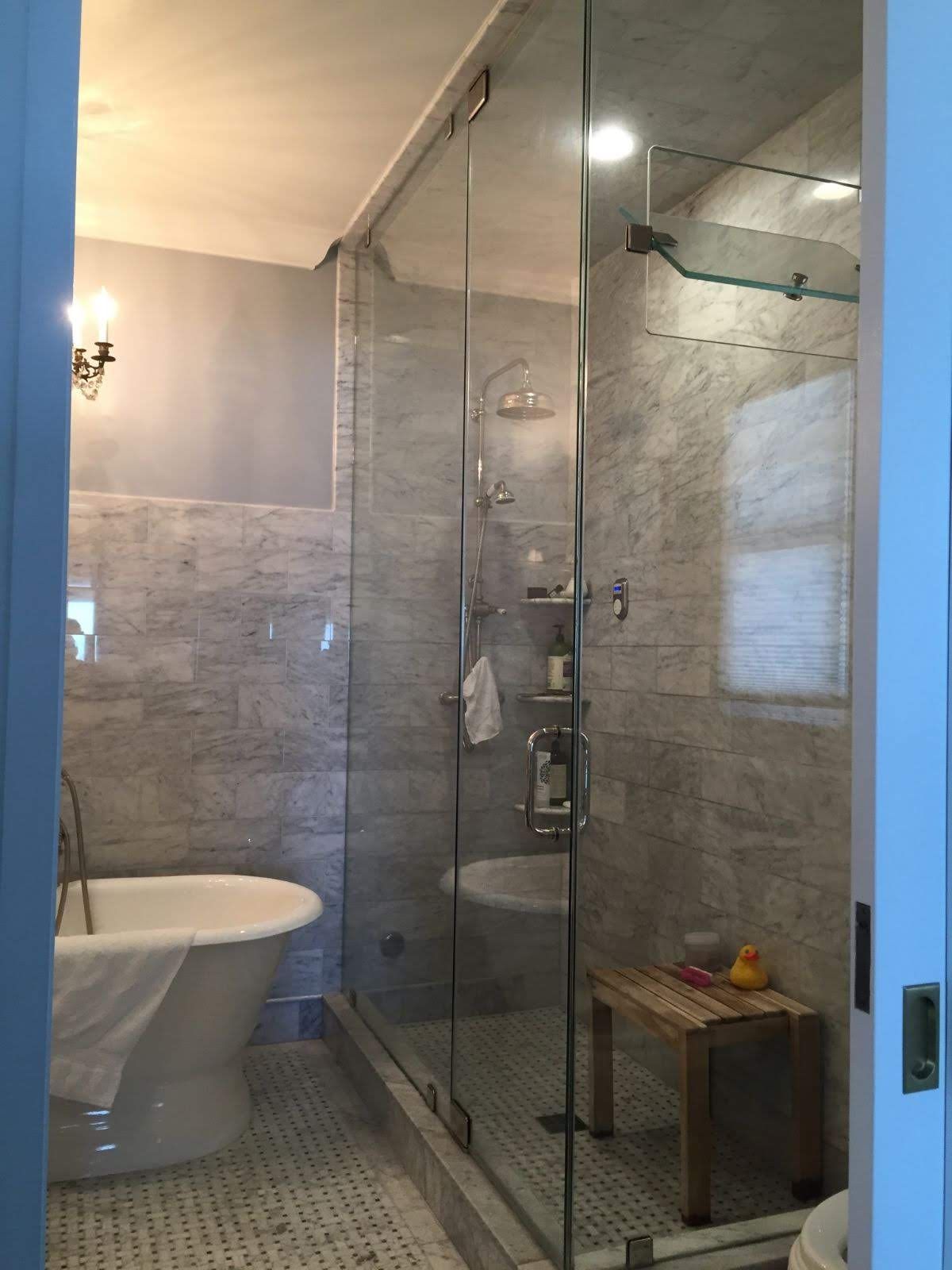 a bathroom with a tub and a walk in shower.