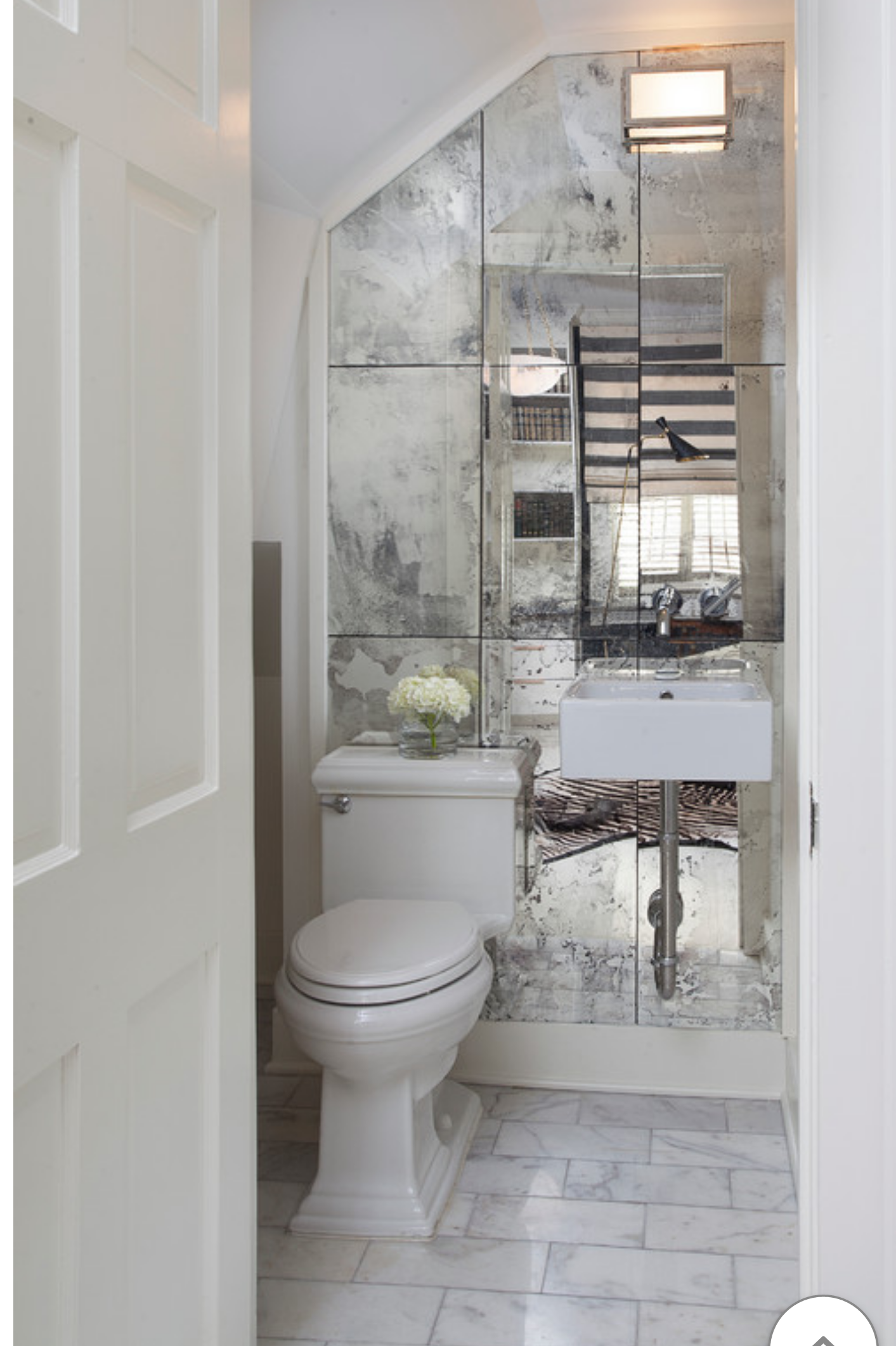 a bathroom with a toilet , sink and mirror.