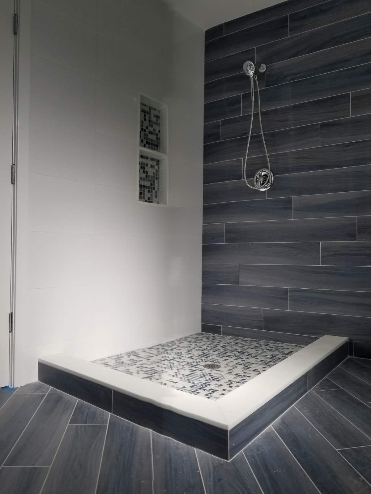 a bathroom with a walk-in shower and a shower head.