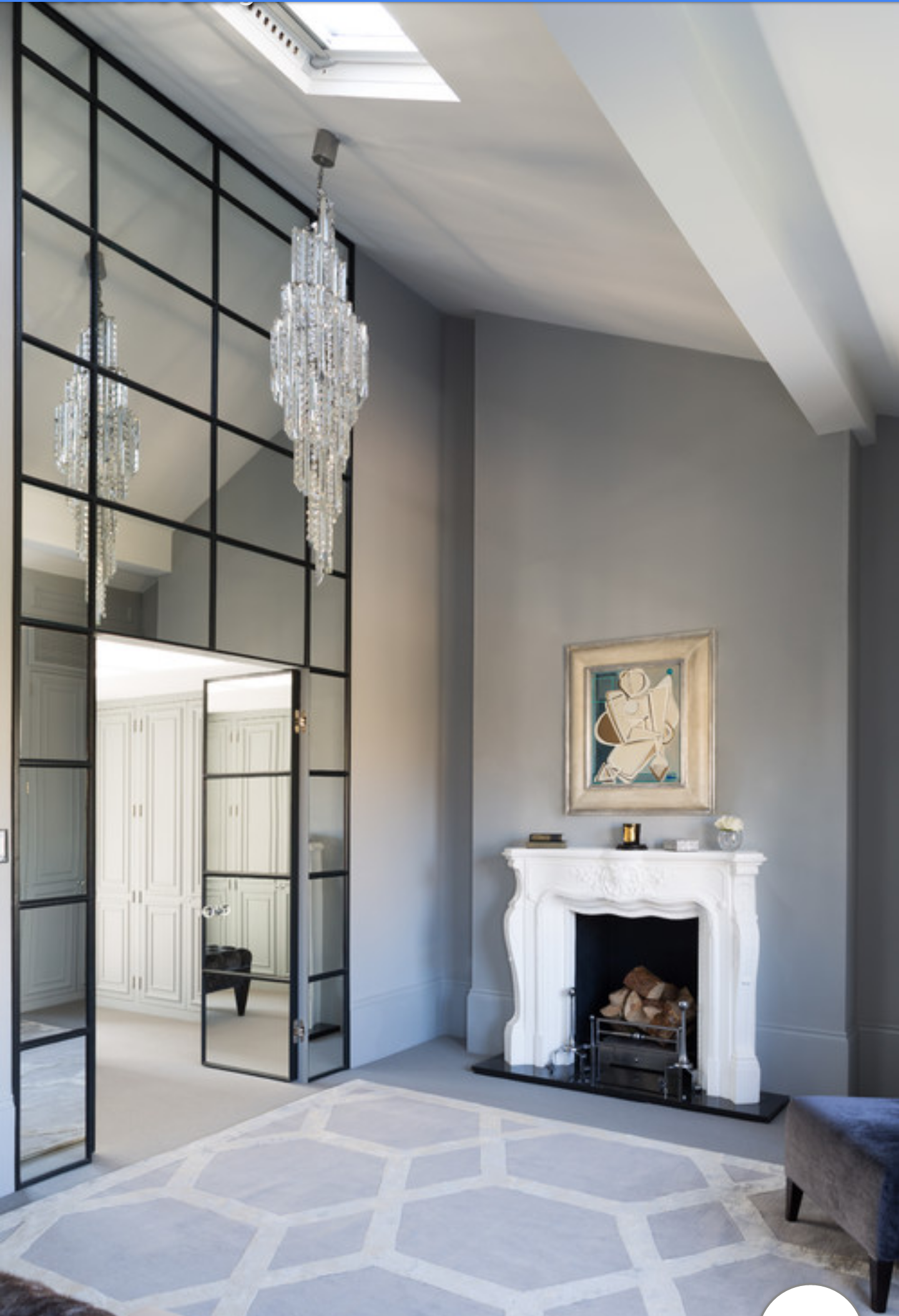 a living room with a fireplace and a chandelier.