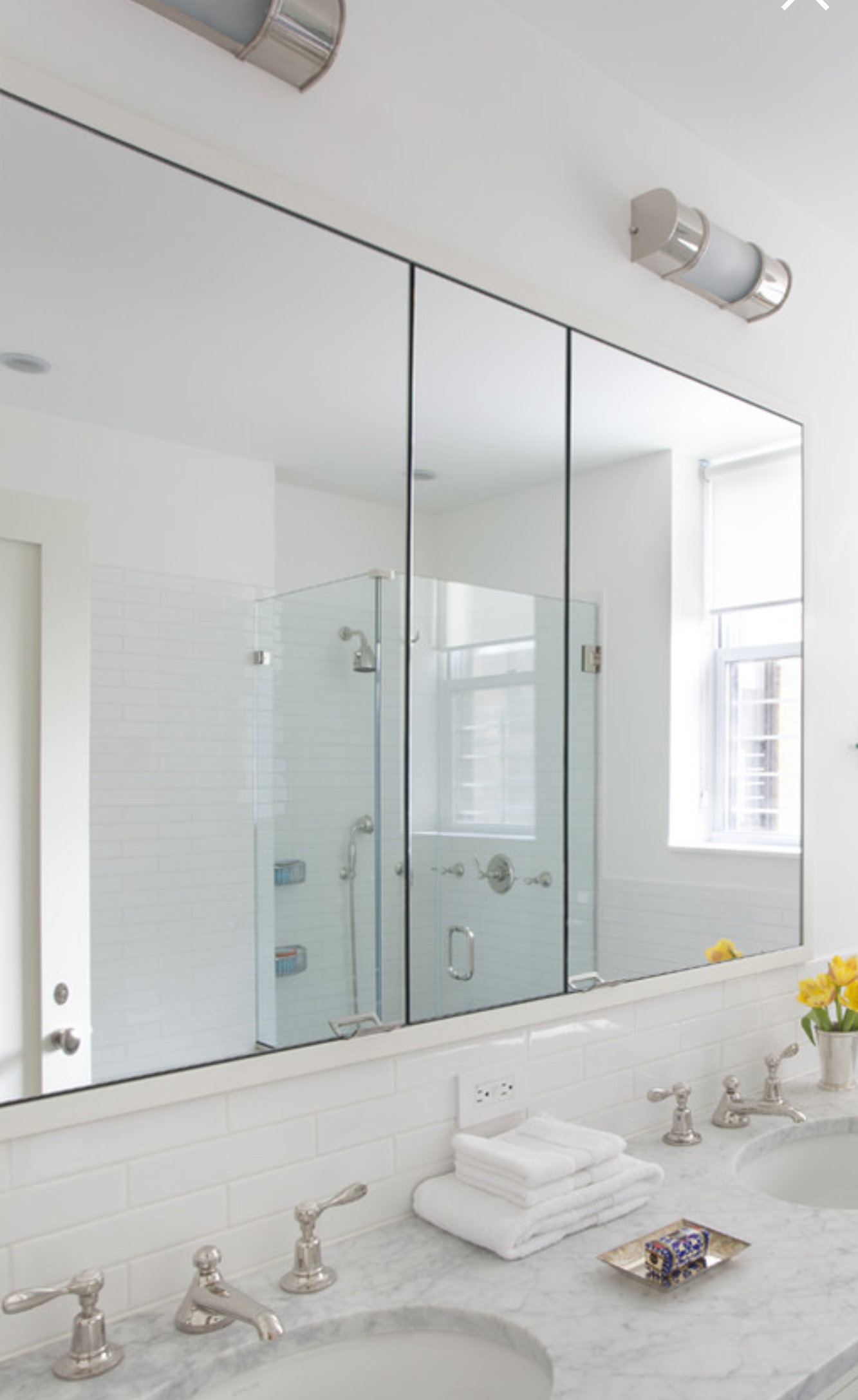 a bathroom with two sinks and a large mirror.
