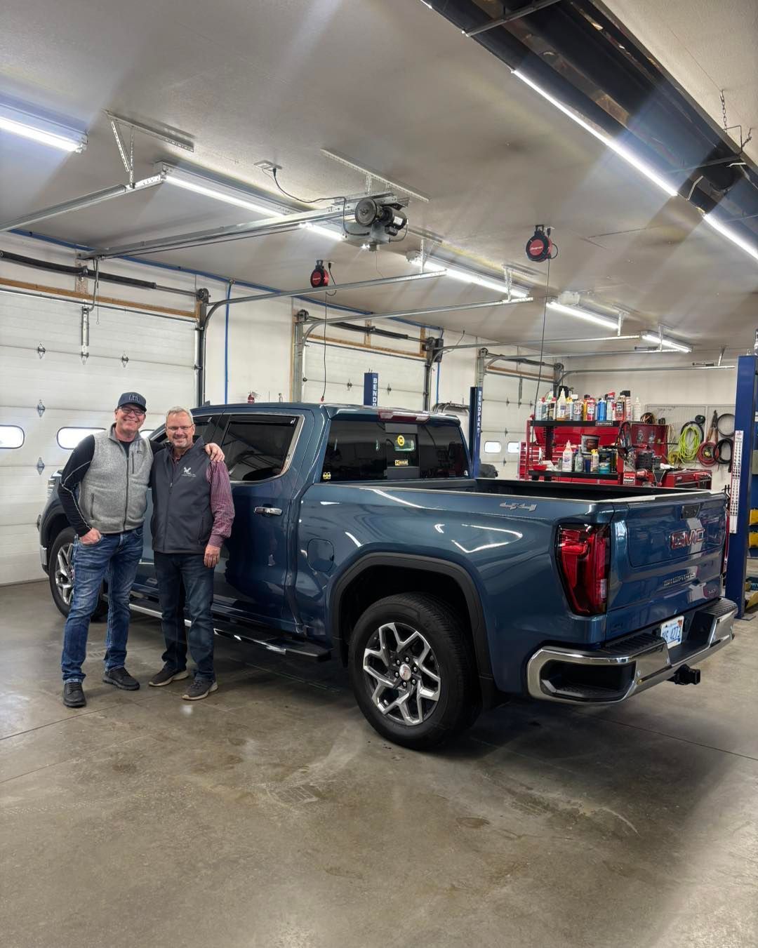 Gray Toyota SUV parked in front of Whitehall Motor Sales on a sunny day.