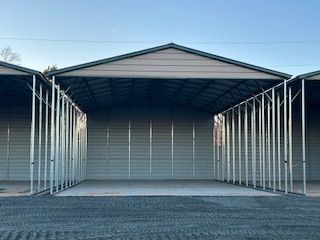 A row of carports are sitting next to each other in a parking lot.