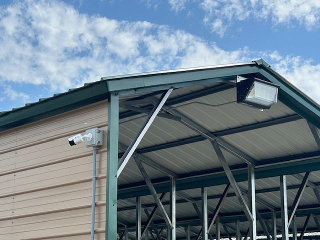 There is a camera on the side of the building.