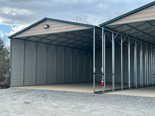 Two trailers are parked in front of a building.