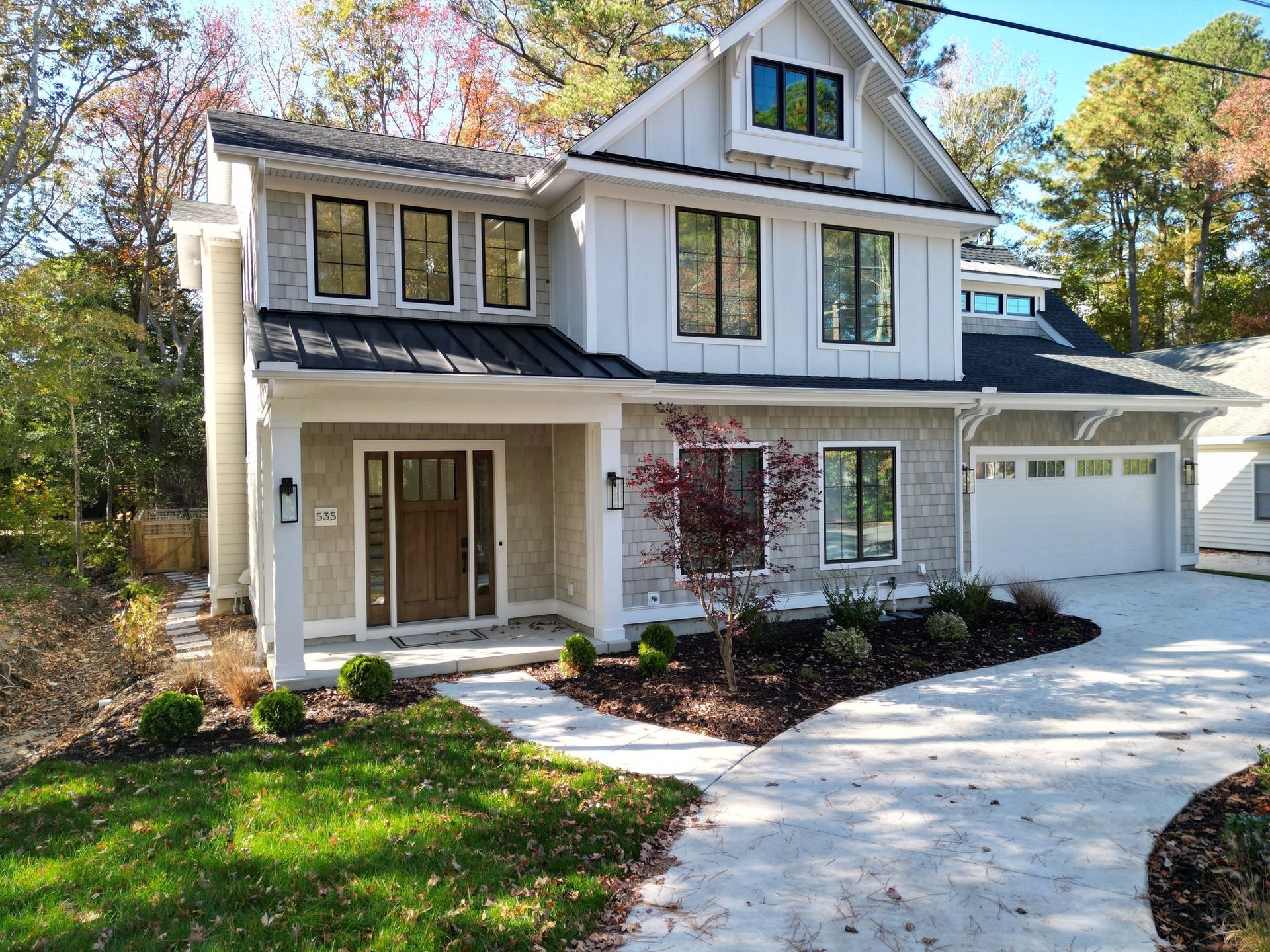 A large white house with a driveway leading to it