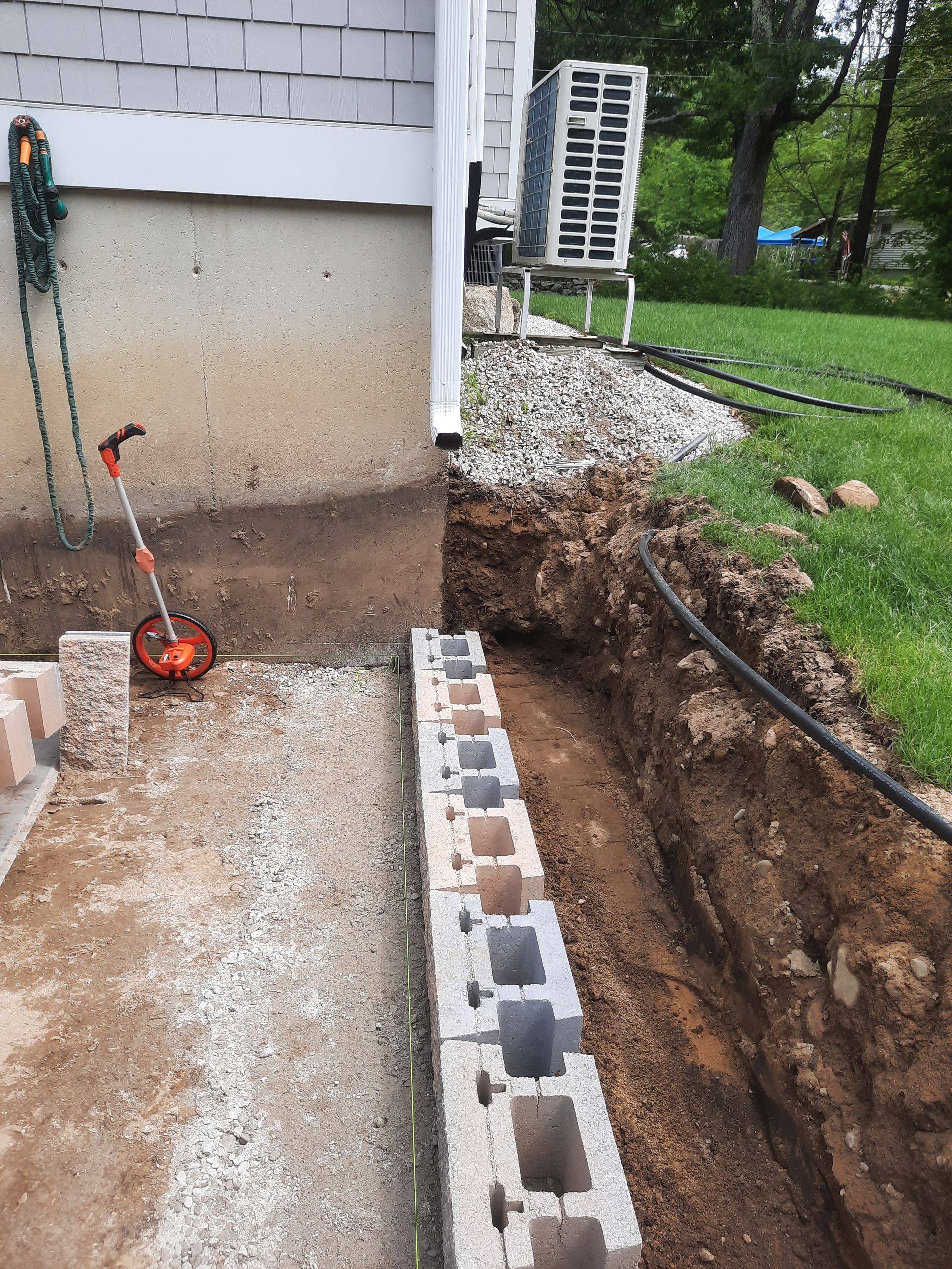 a brick wall is being built next to a house