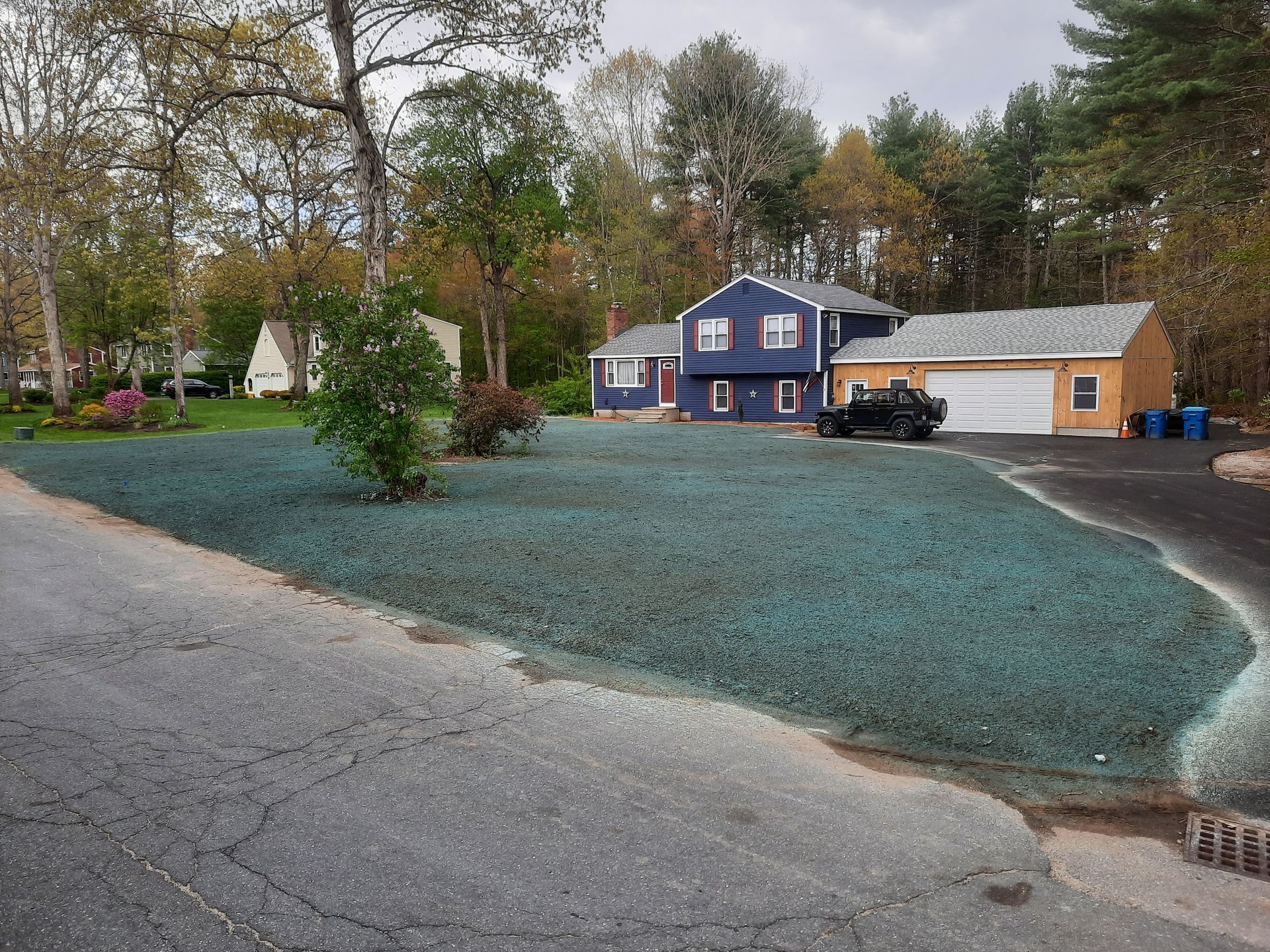 a blue house with a black truck parked in front of it