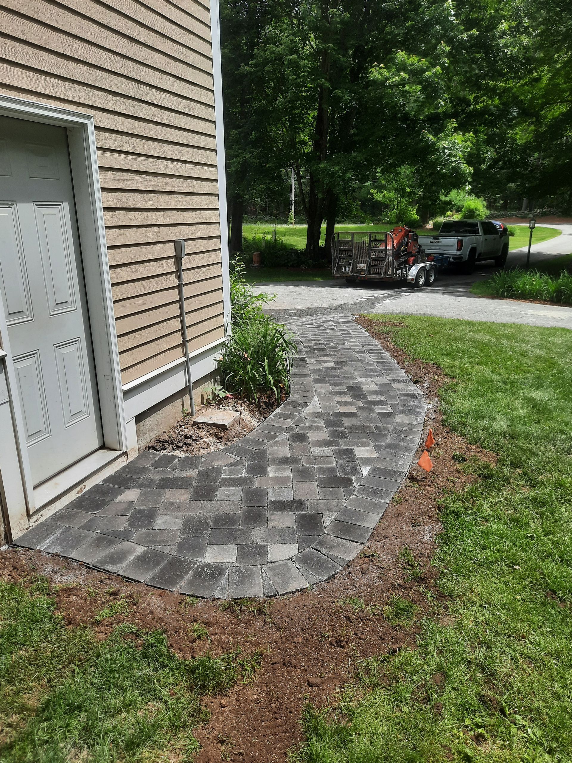a brick walkway is being built in front of a house