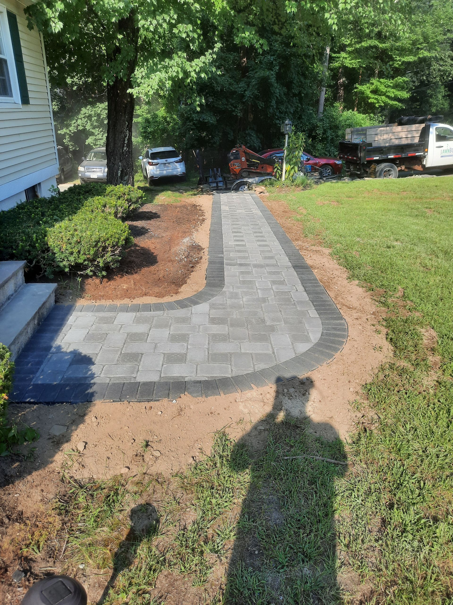 a brick walkway is being built in front of a house