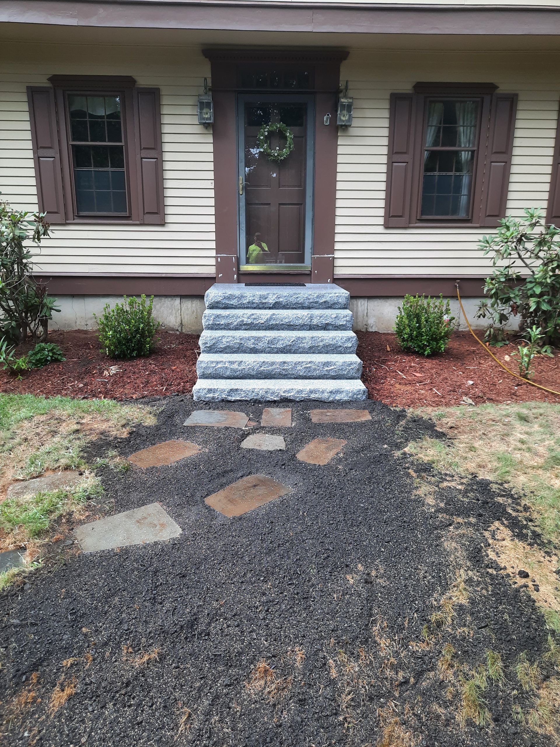 a house with stairs leading up to the front door