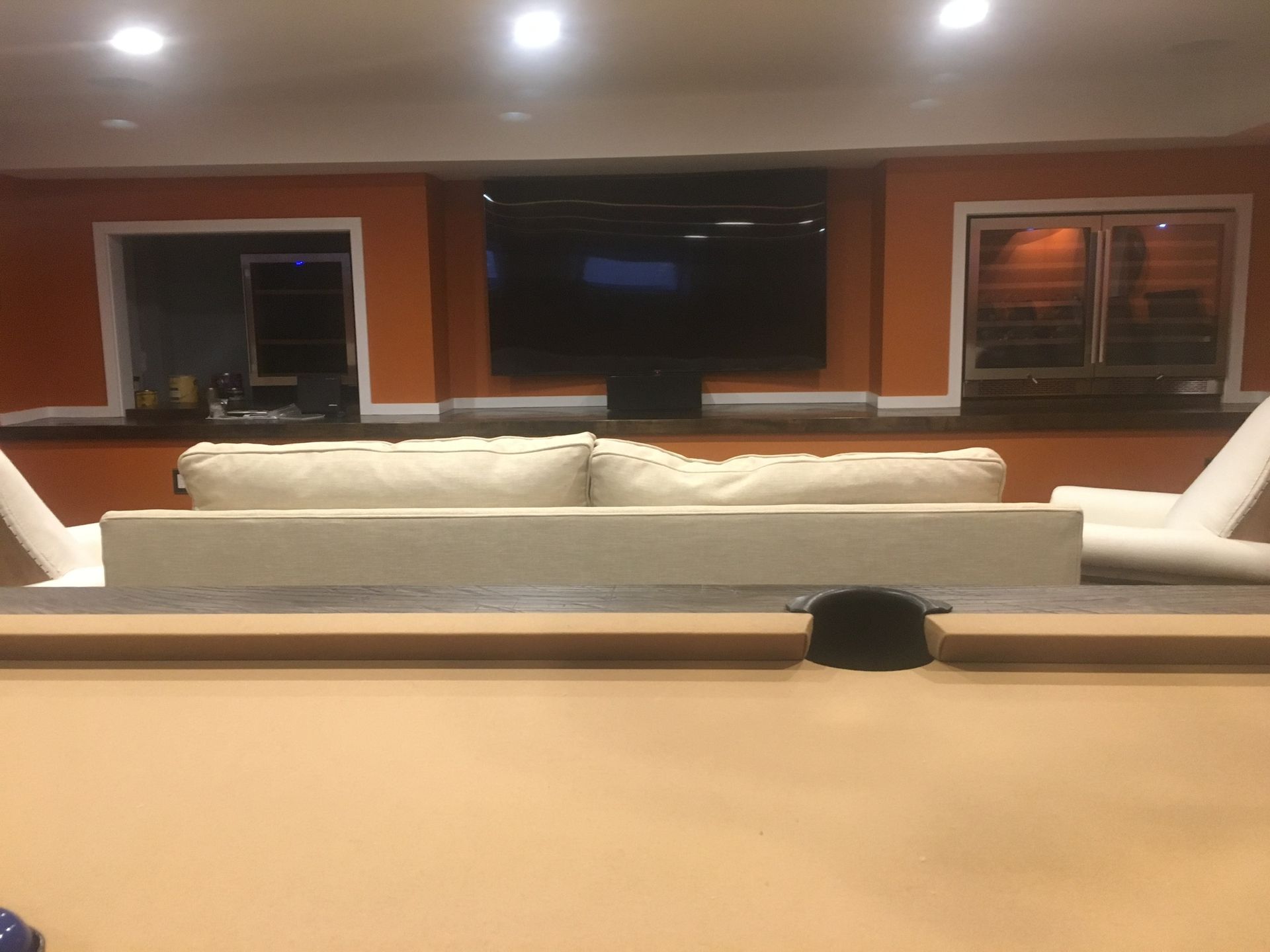 tv mounted on a brown wall