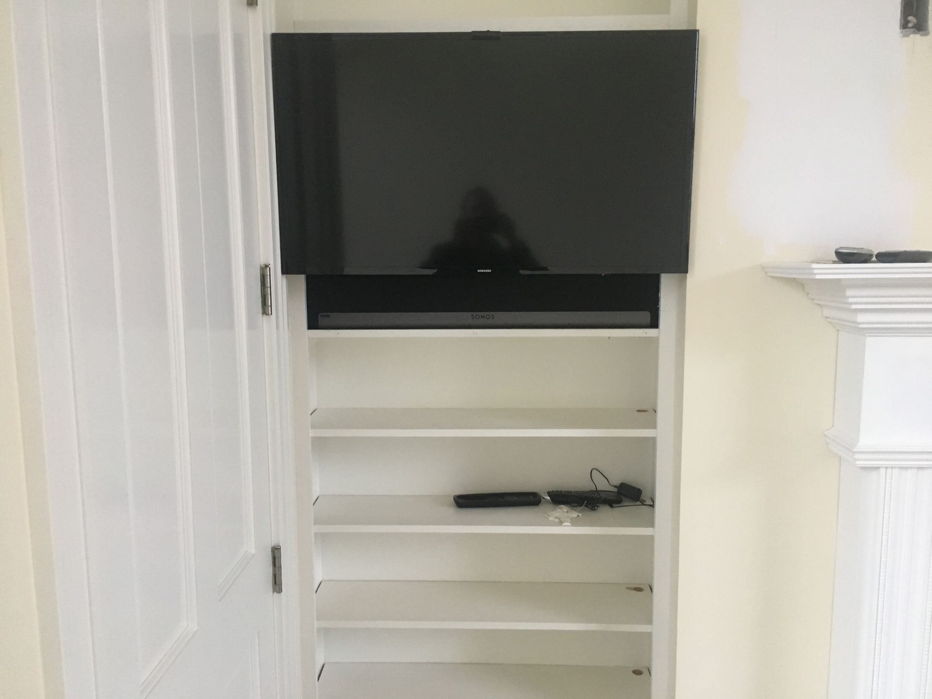 tv mounted above the open storage space