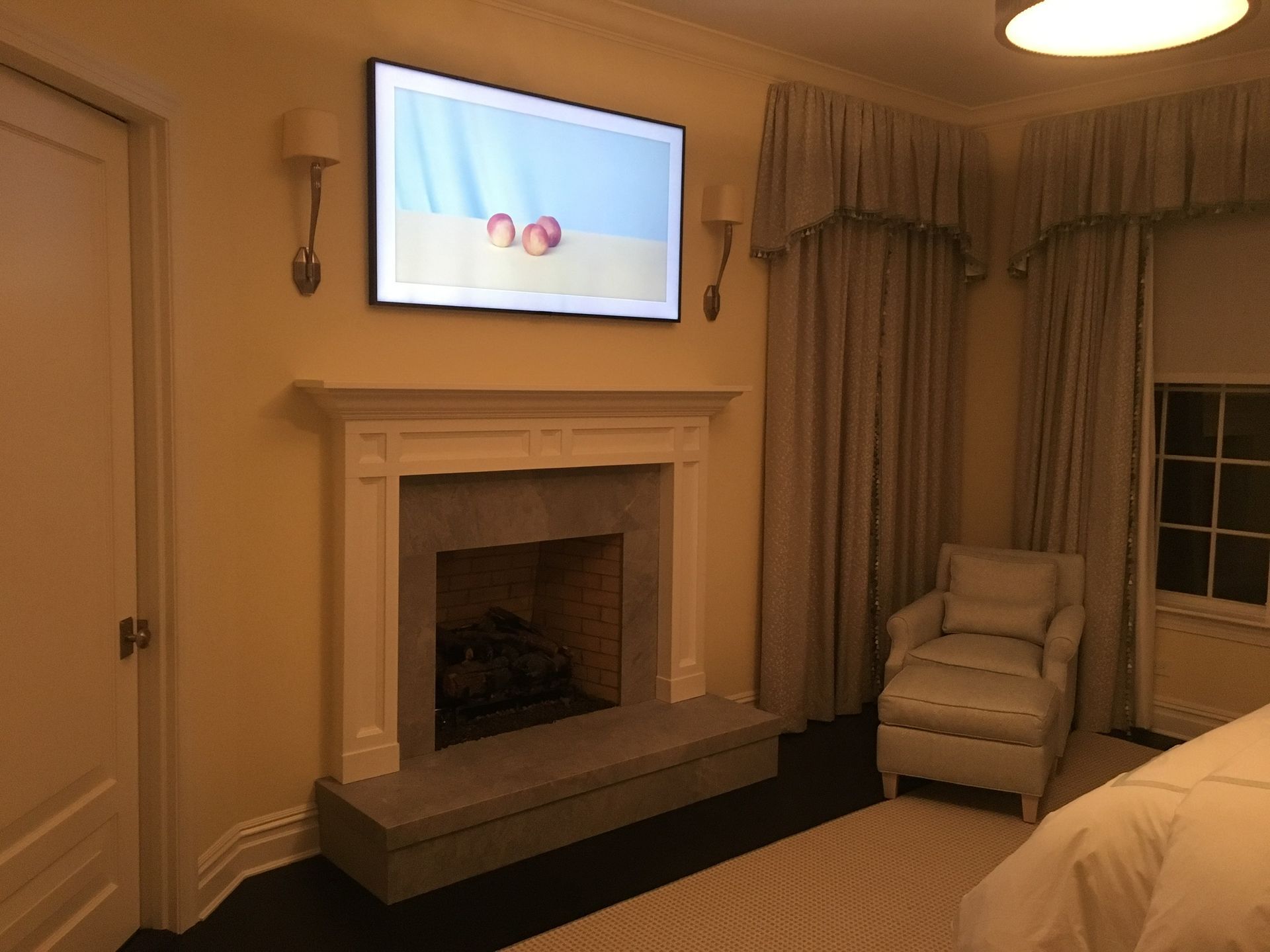 tv mounted on the bedroom wall