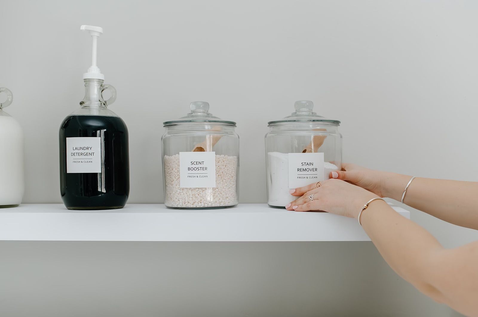 A person is reaching for a jar on a shelf