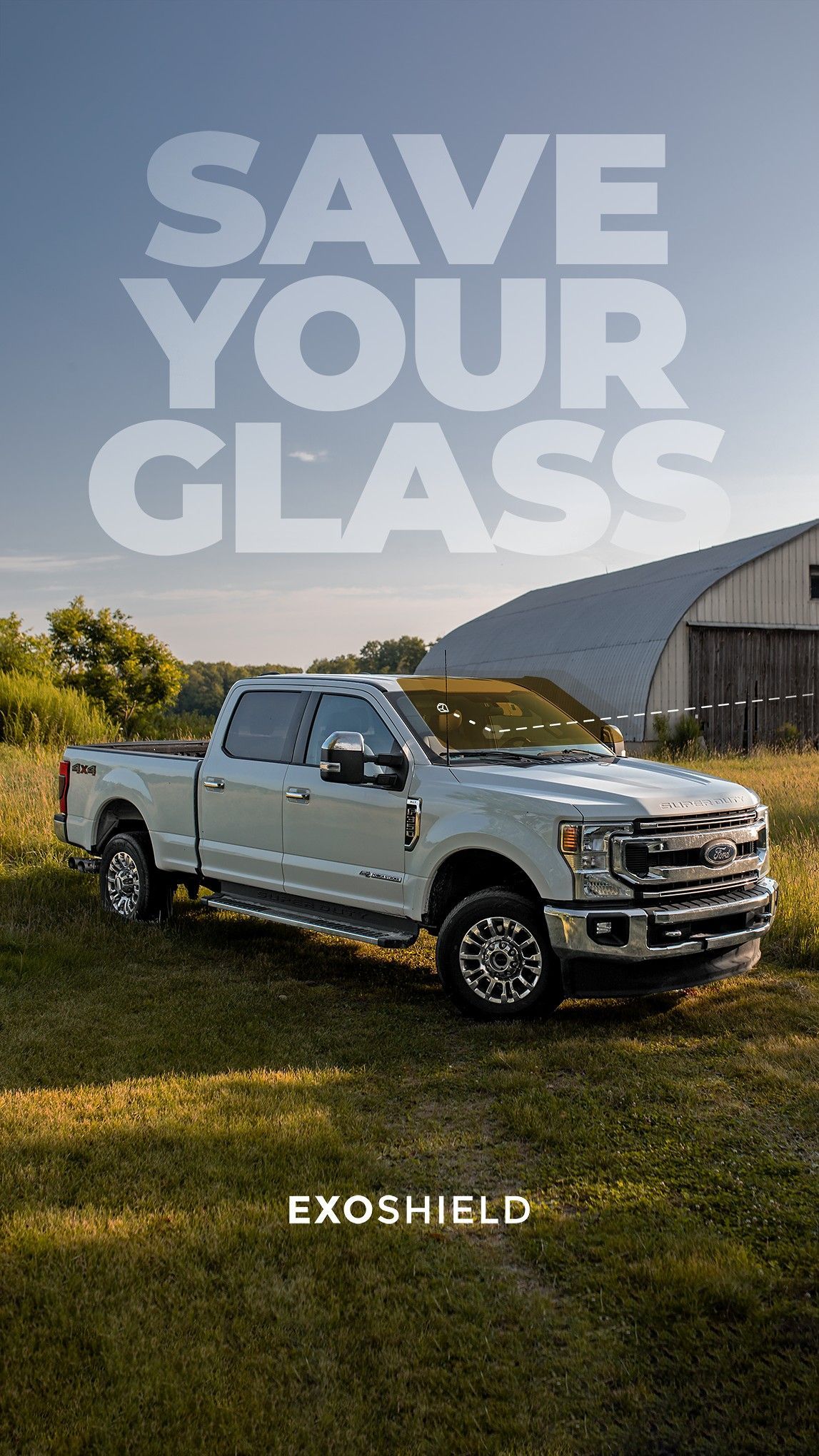 White pickup truck in a grassy field with large text reading “SAVE YOUR CLASS” and “EXOSHIELD” below