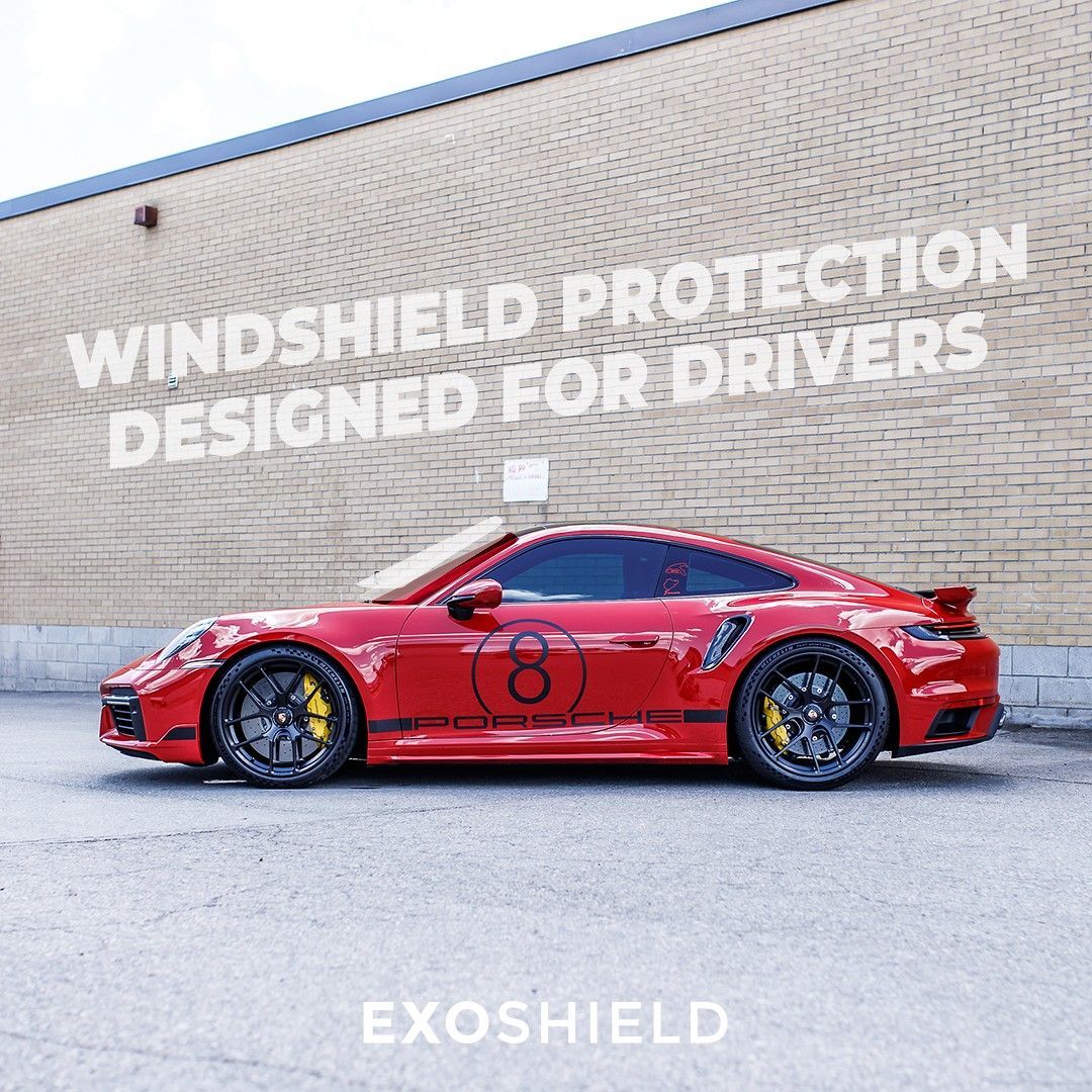 Red sports car parked by a wall with the text “Windshield protection designed for drivers” and “EXOSHIELD”