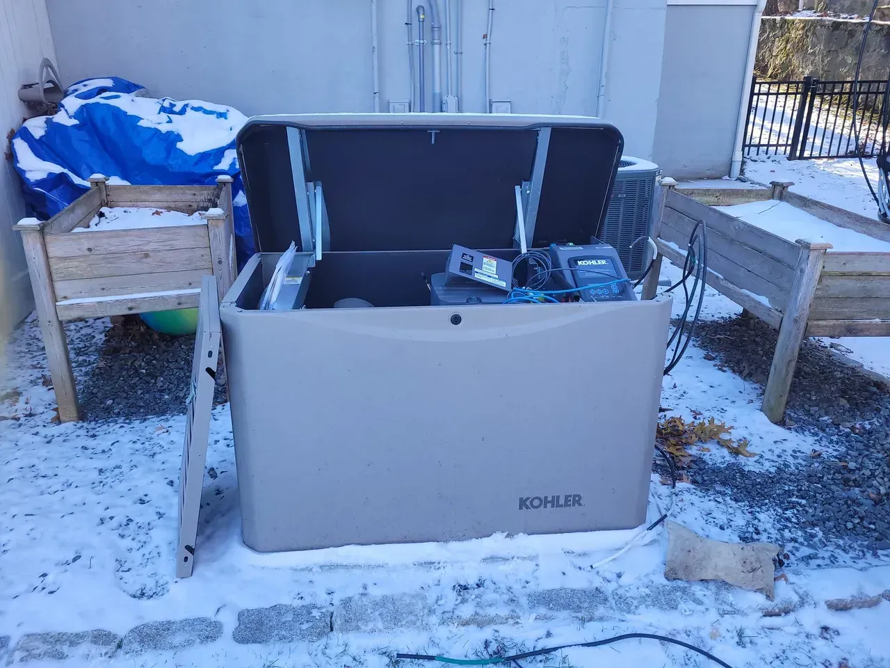 A kohler generator is sitting in the snow.