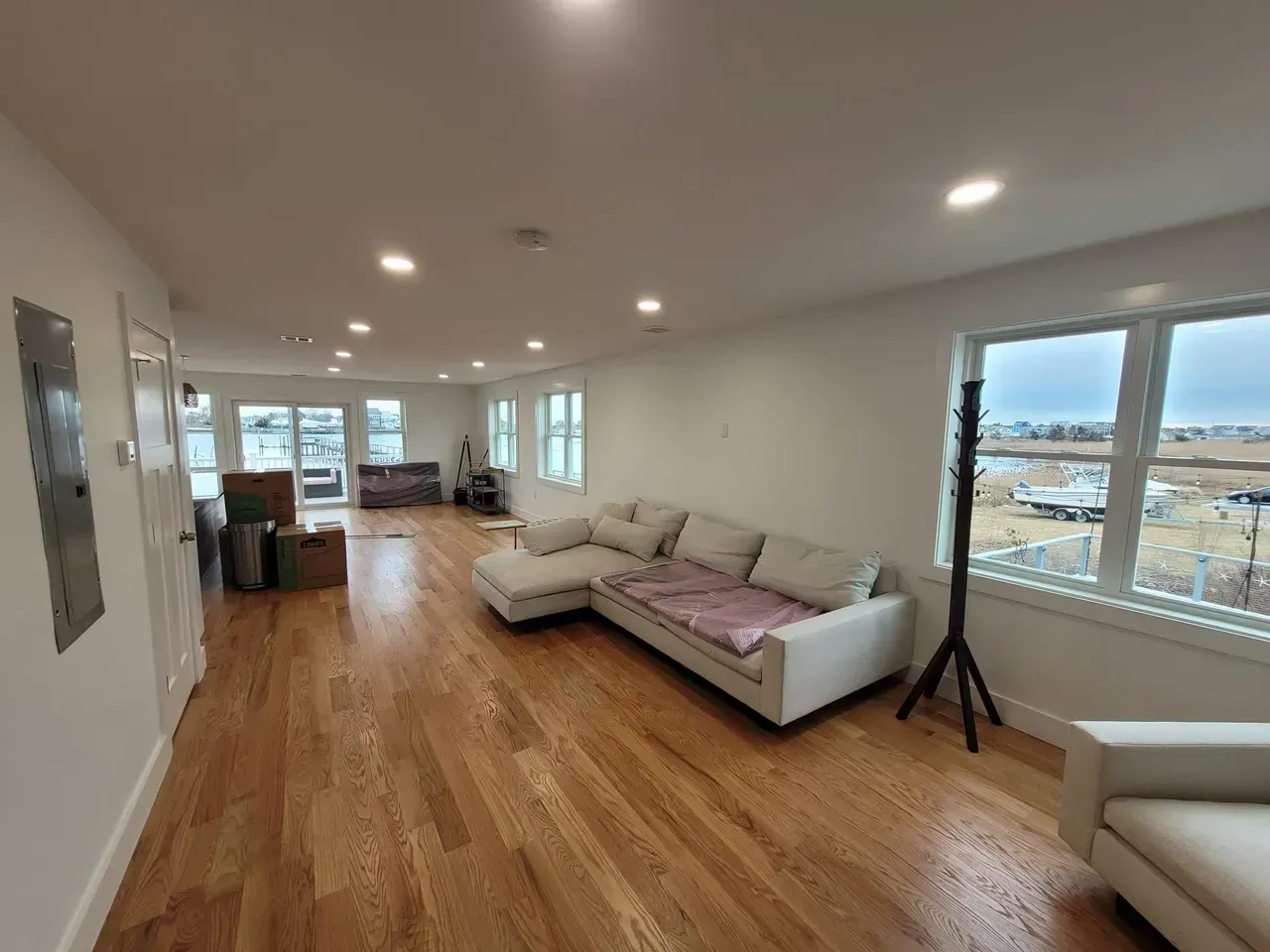 A living room with hardwood floors and a white couch.
