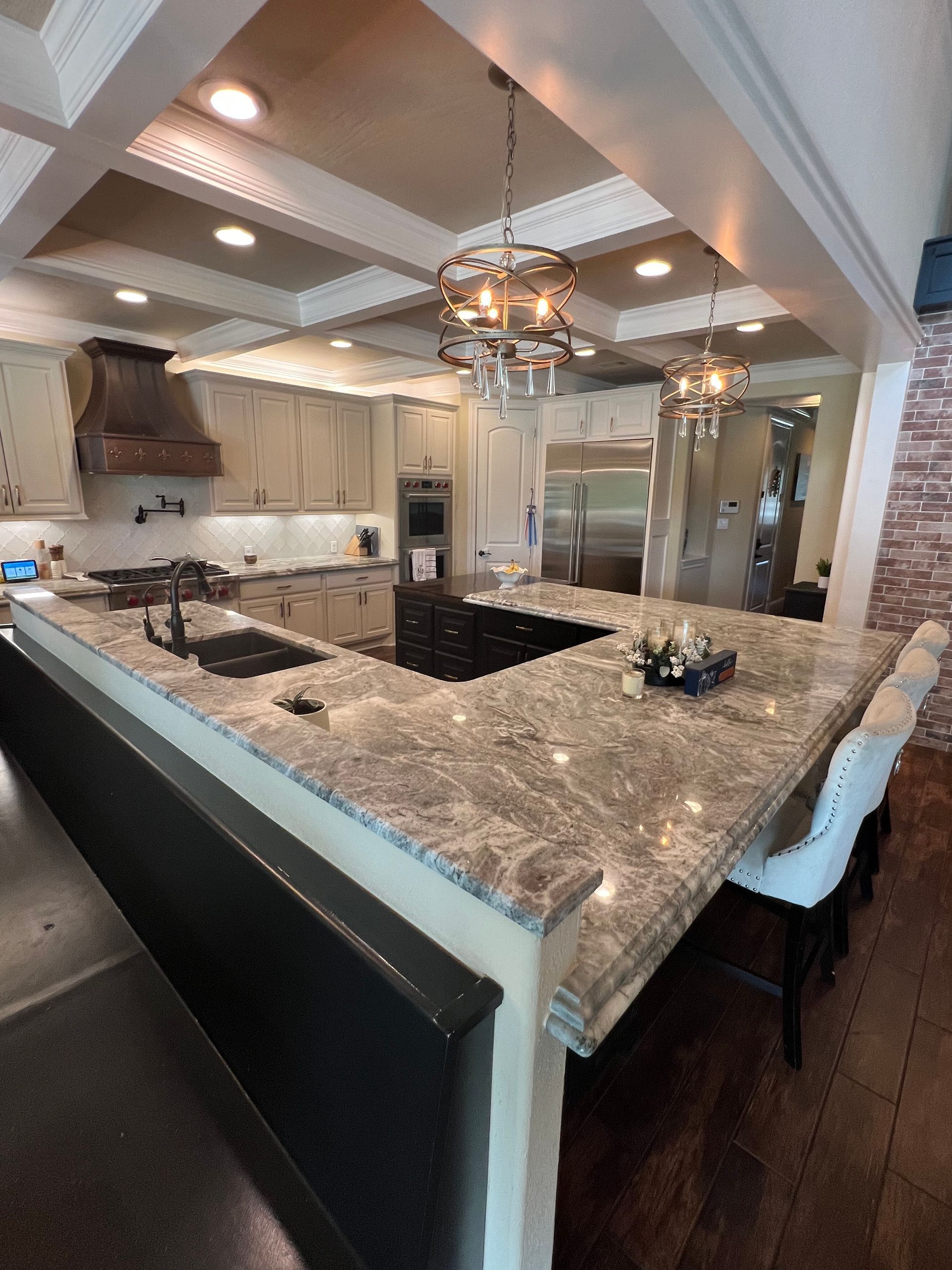 A kitchen with granite counter tops and stainless steel appliances
