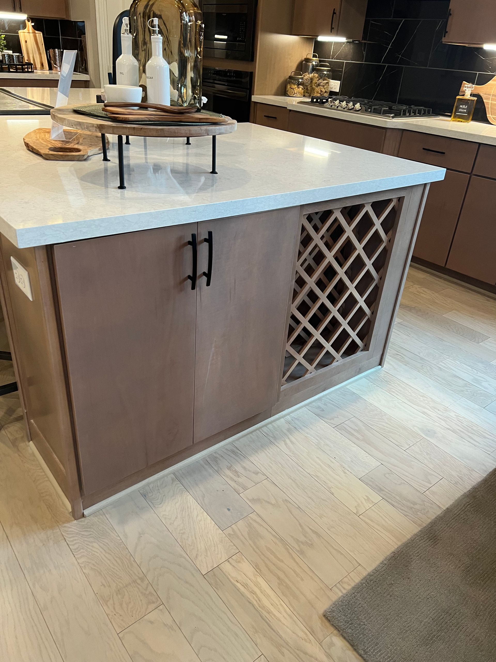 A kitchen with a wine rack on the island.