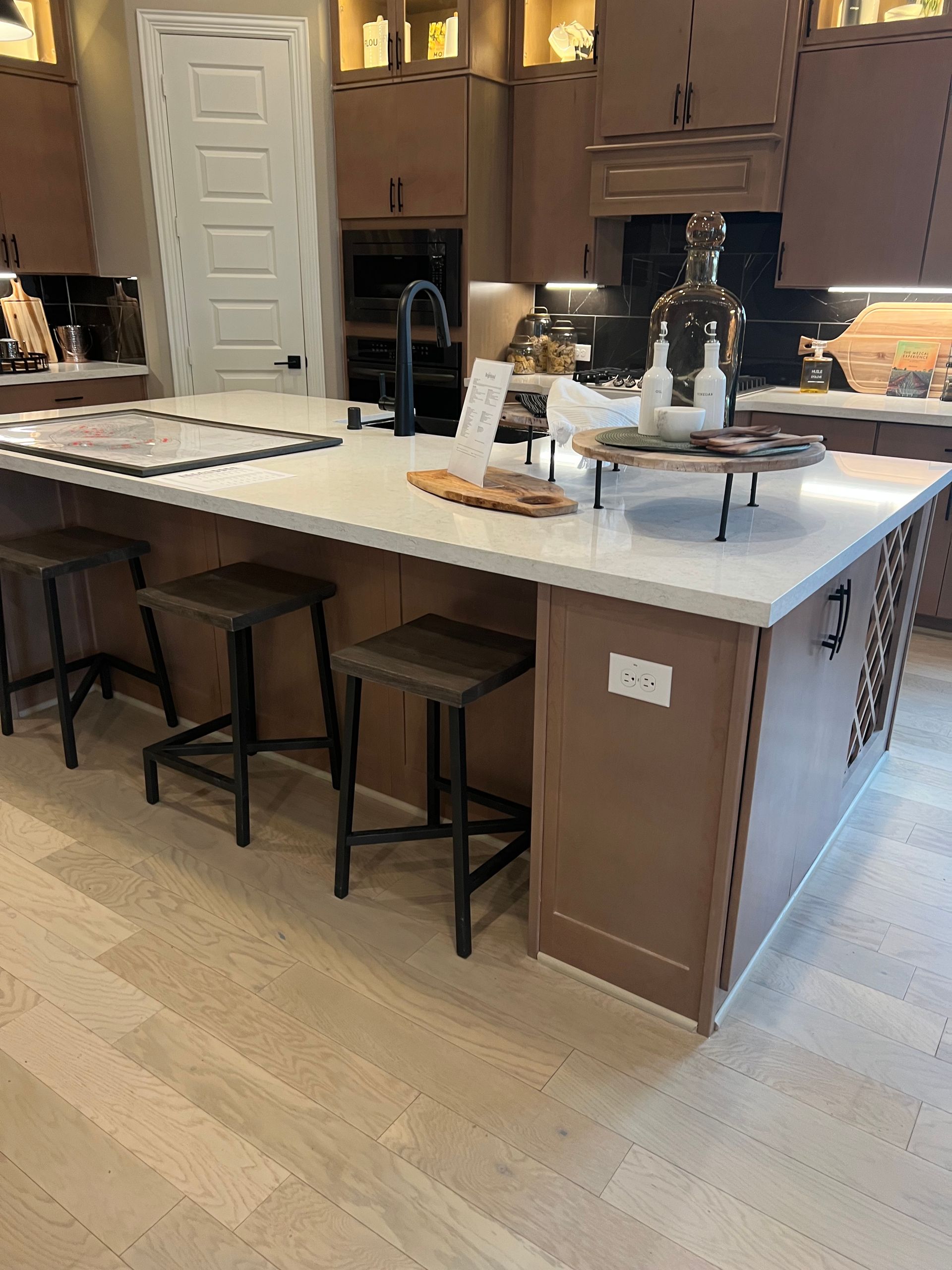A kitchen with a large island and stools.