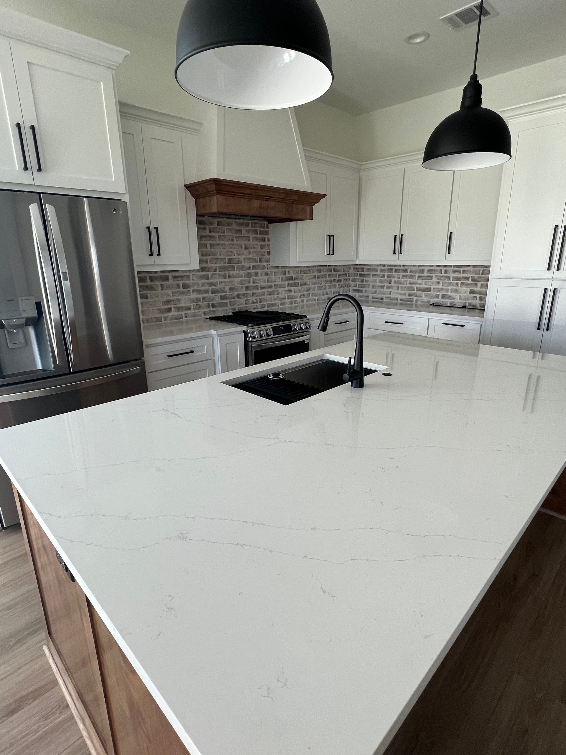 A kitchen with a large island and a sink