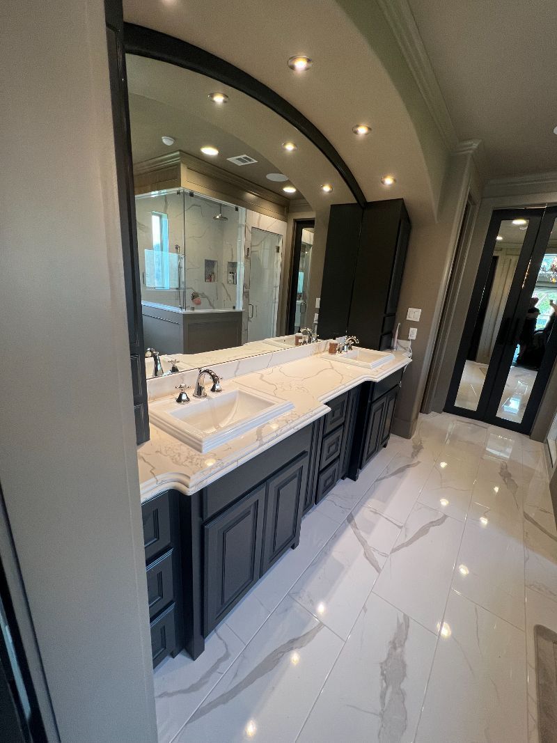 A bathroom with two sinks and a large mirror.