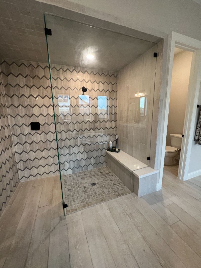 A bathroom with a walk in shower and a toilet.