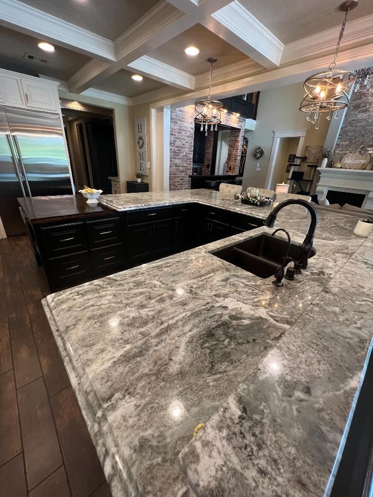 A kitchen with granite counter tops and a sink.