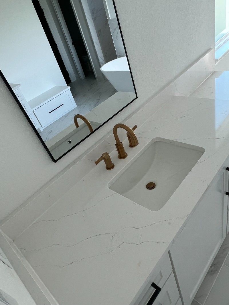 A bathroom with a sink , mirror and tub.