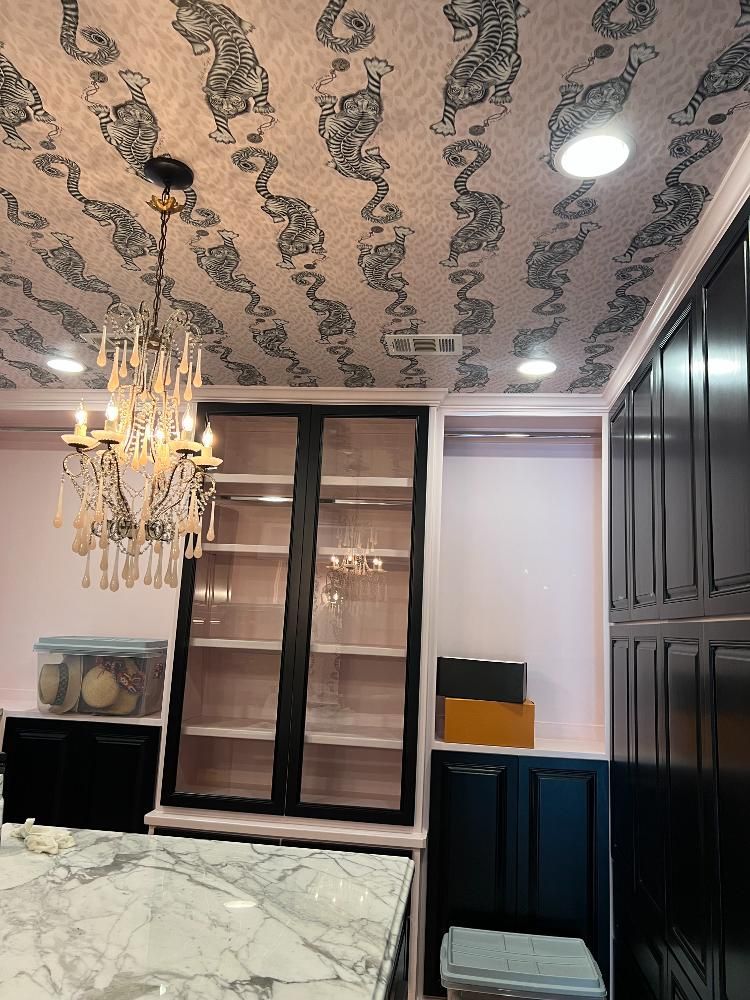 A kitchen with a chandelier hanging from the ceiling.