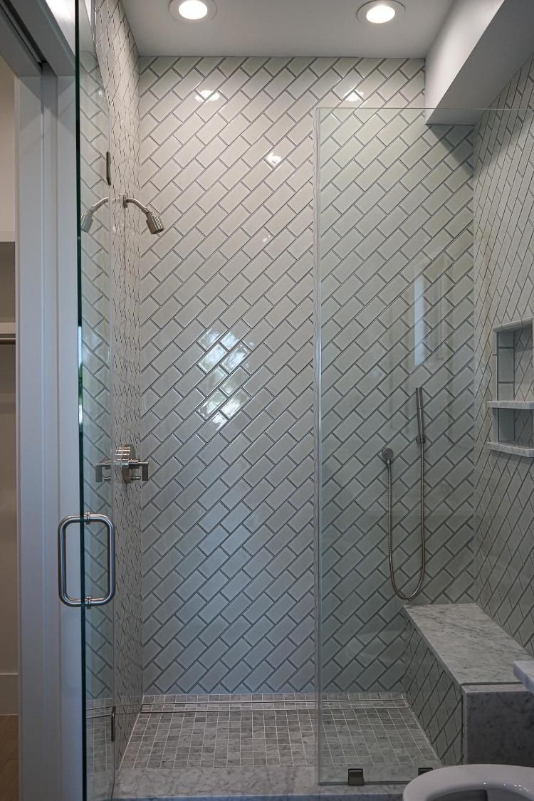 A bathroom with a walk in shower and a toilet.