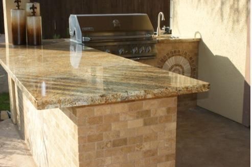 A large granite counter top with a grill on top of it