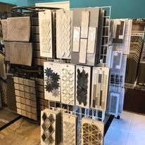 A display of tiles hanging on a rack in a store.