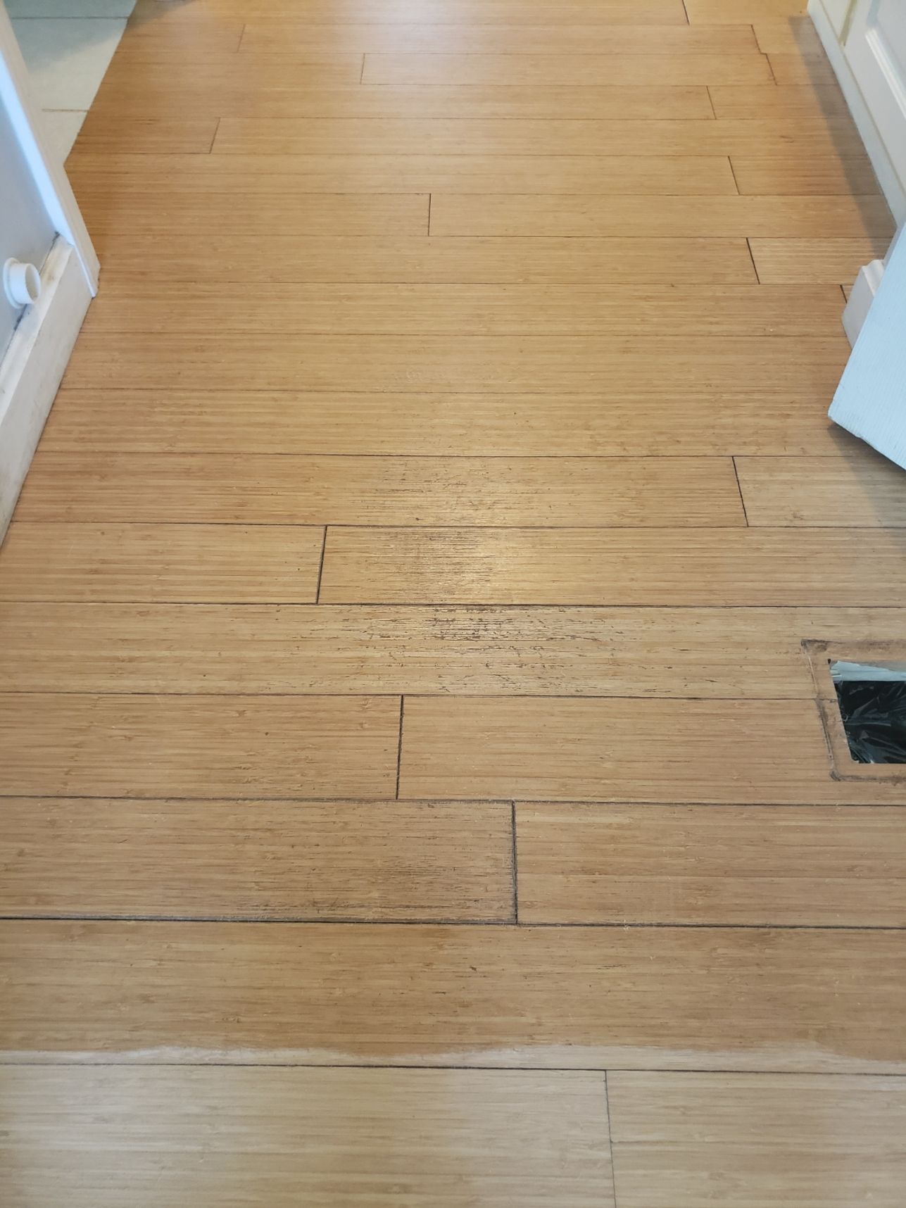A wooden floor with a hole in the middle of it