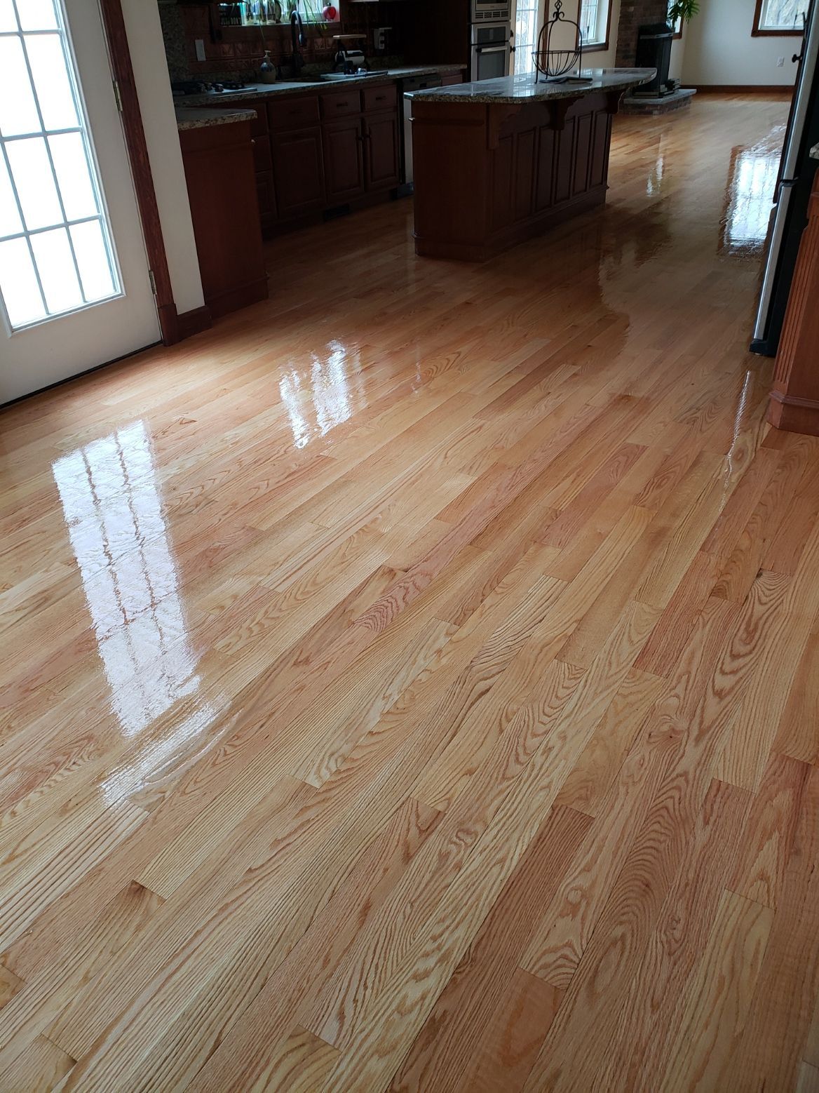 A kitchen with hardwood floors and a large island