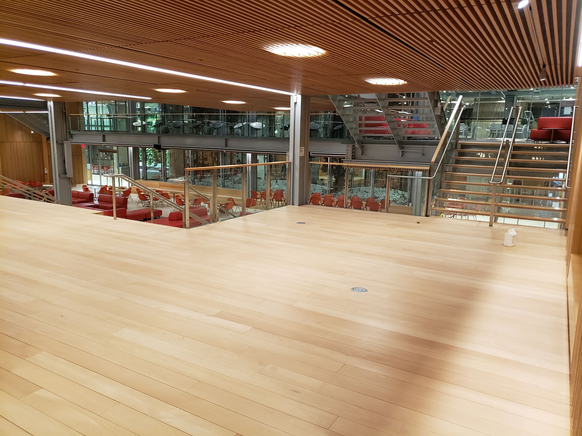 A large room with stairs and a wooden floor