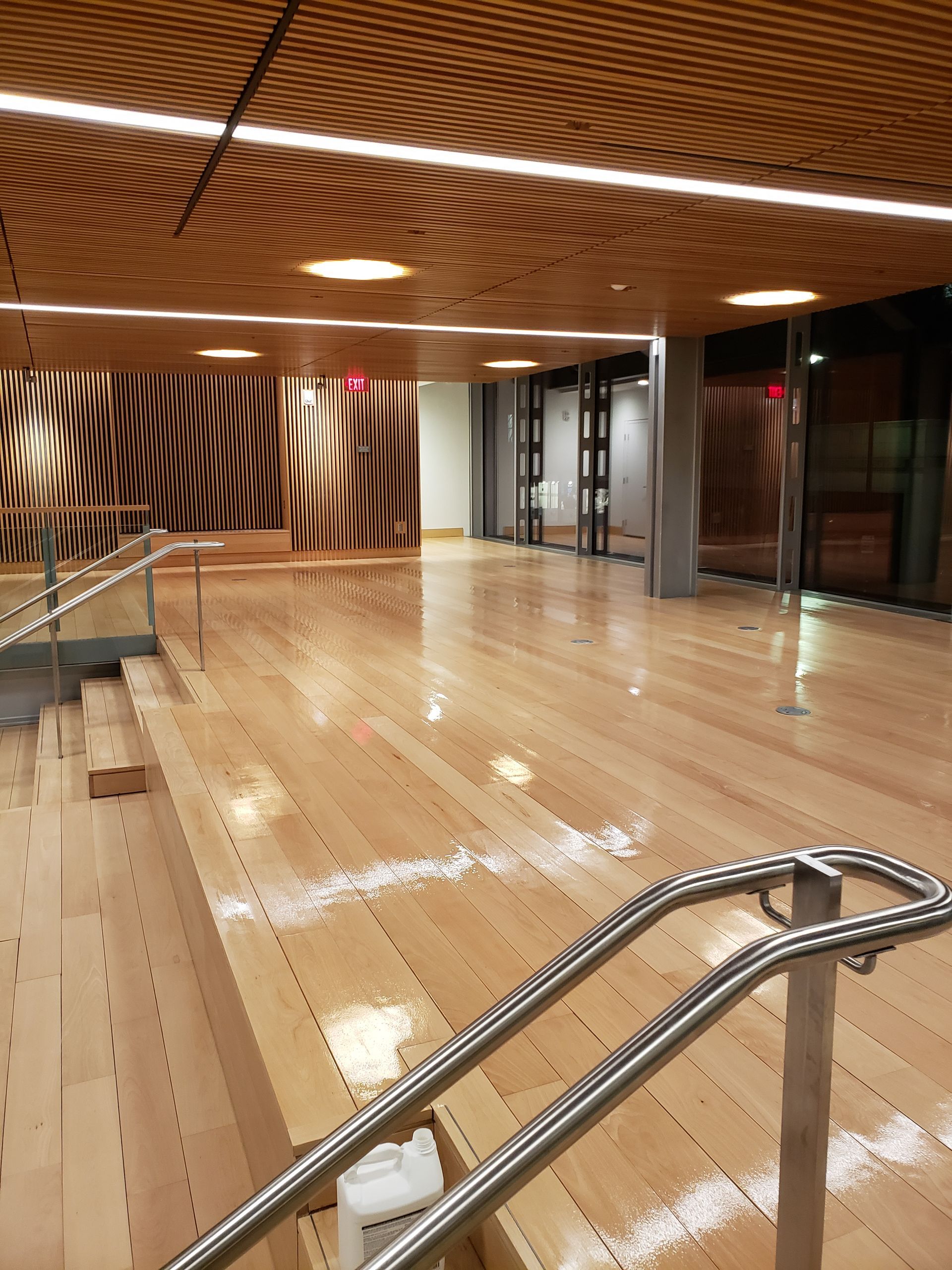 A large empty room with wooden floors and stairs